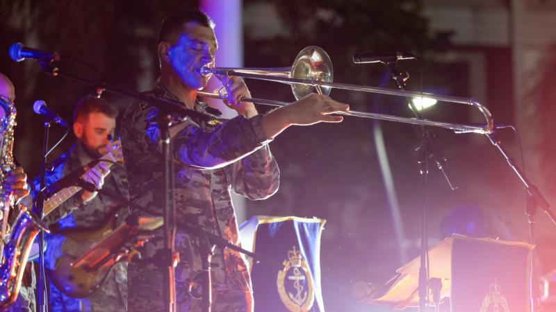 Petty Officer Musician Daniel McMahon plays the trombone at a community barbeque event in Apia, Samoa as part of a South West Pacific Regional Presence Deployment by HMAS Choules in July 2024.