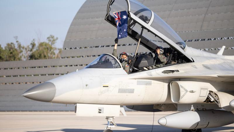 A Philippine Air Force FA-50PH pilot holds an Australian National Flag after arriving at RAAF Base Darwin, ready for Exercise Pitch Black 24.