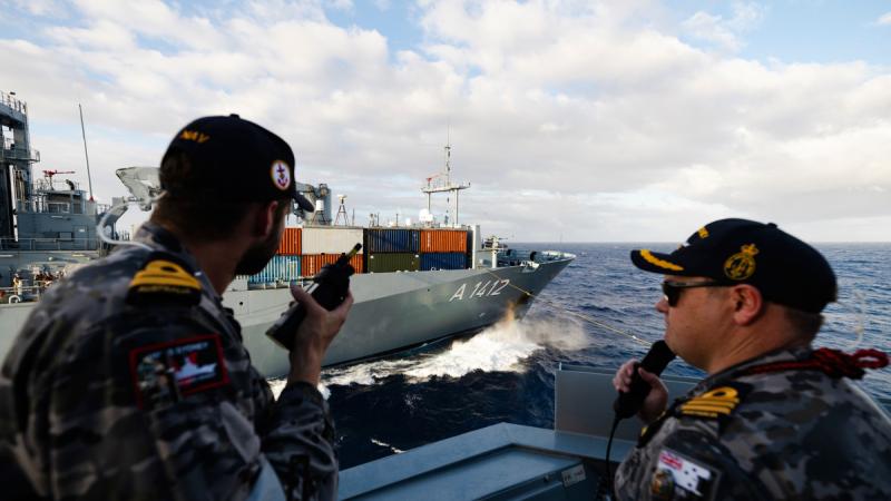 Lieutenant Nicholas Dale and Commanding Officer HMAS Sydney, Commander David “Billy” Maddison, steer the ship during a Replenishment at Sea with German Navy Ship Frankfurt Am Main during Exercise Rim of the Pacific 2024. Photos: Leading Seaman Daniel Goodman