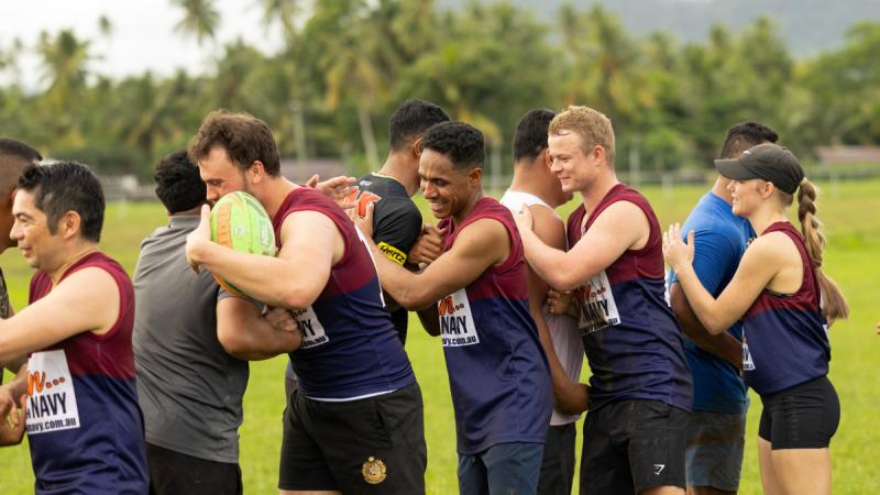 Members of the Samoan Police Service and ship’s company of HMAS Choules congratulate each other after the completion of a friendly touch football match in Apia, Samoa.