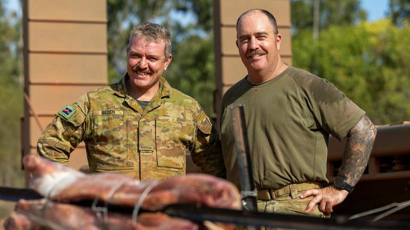 Private Frank Seden, from 8th/12th Regiment, Royal Australian Artillery, and Corporal Jerry Jones, with the roast they prepared for soldiers taking part in Exercise Predator's Run. Photos: Corporal Jacob Joseph.