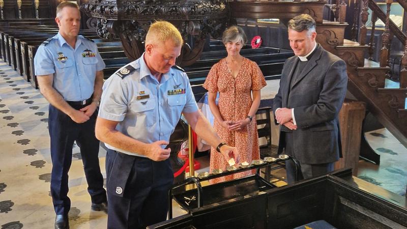 The lighting of the candle ceremony; from left to right Air Marshal Stephen Chappell, Warrant Officer of the Air Force Ralph Clifton; Saskia Hobbs and Reverend Mark Perry. 