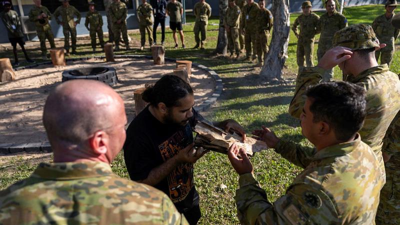 Indigenous Gimuy-Walubara man Jiritju Fourmile conducts a smoking ceremony with members of the 51st Battalion, Far North Queensland Regiment, to celebrate the opening of a new yarning circle at Porton Barracks in Cairns. 