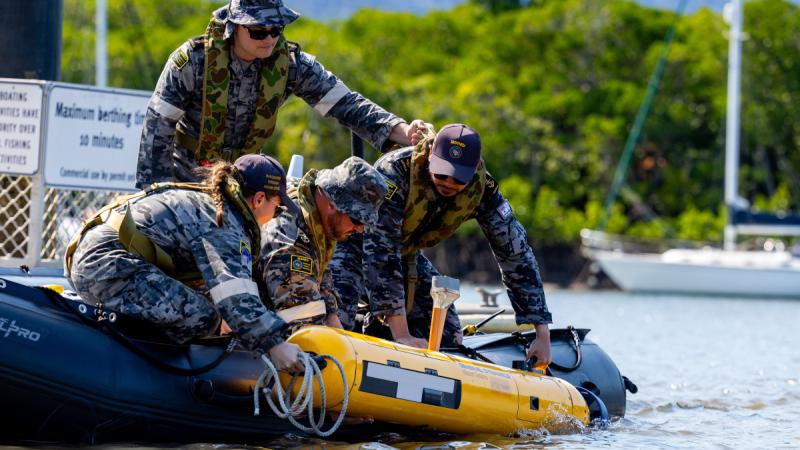 Royal Australian Navy sailors lower a Bluefin-9 autonomous underwater vehicle into Cairns Inlet near HMAS Cairns as part of Exercise Austral Shield 2024.