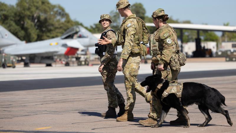 A Royal Air Force Corporal (L), Royal Australian Air Force Leading Aircraftman Benjamin Selwood, Royal New Zealand Air Force Corporal Rikki Rawleigh and Patrol Dog McClane, patrol the apron at RAAF Base Darwin during Exercise Pitch Black 24.