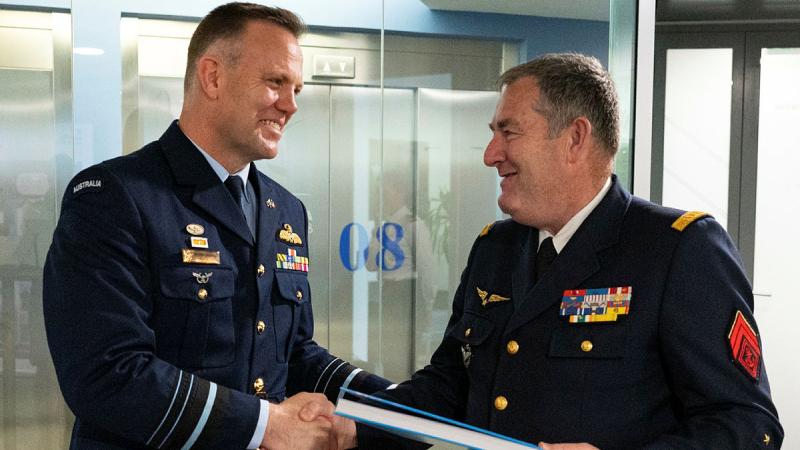 Chief of the Royal Australian Air Force Air Marshal Stephen Chappell gifts General Stéphane Mille, Chief of the French Air and Space Force with a book on Australia. 