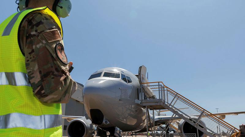 Staff Sergeant Ian McLain from the United States Air Force monitors the E-7A Wedgetail from 2 Squadron before its next mission during Exercise Pitch Black 24.