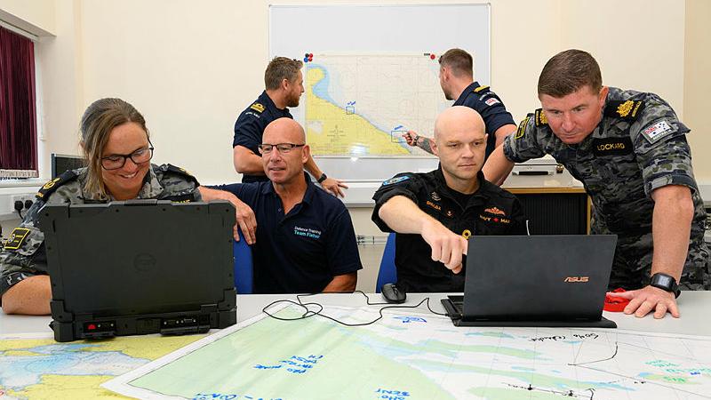 Australian and Canadian Naval personnel work with Royal Navy and civilian staff during the advanced mine warfare course at HMS Collingwood in England. 