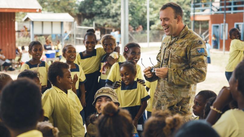 An Australian Army soldiers deployed to the Solomon Islands engage with the local community of Honiara.