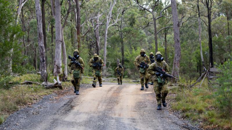 Soldiers from the Sydney University Regiment patrol through the Holsworthy Training Area, Sydney, during a chemical, biological, radiological and nuclear decontamination serial.
