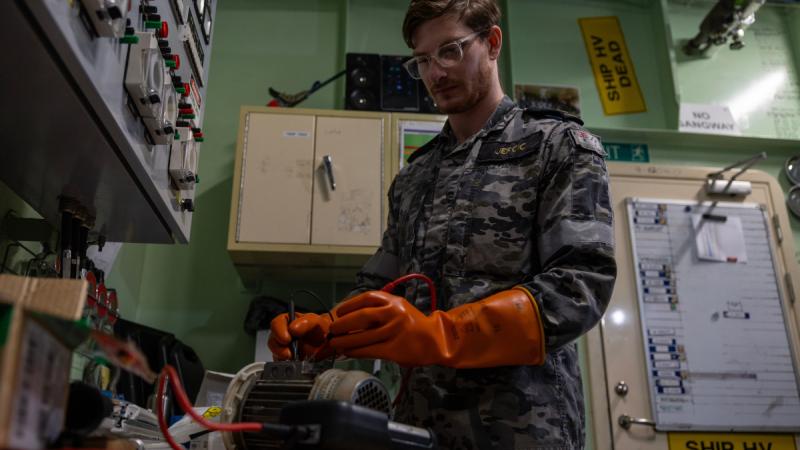 Royal Australian Navy sailor Leading Seaman Marine Technician Electrical Nikolas Jercic conducts electrical testing on board HMAS Adelaide.