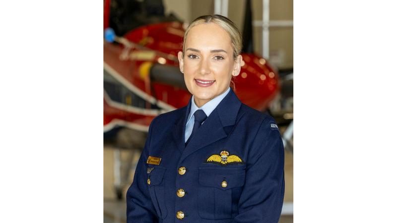 Now Flying Officer Freya Swinbourne in front of a Pilatus PC-21 aircraft after graduating as a pilot from 1 Flying Training School 's Intermediate Pilots’ Course. 