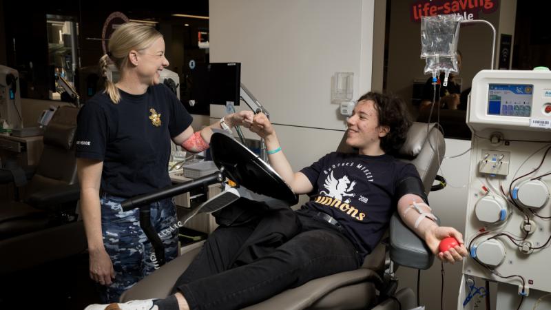 Squadron Leader Emma Kay, left, with a member of the public making a donation at the Lifeblood Centre in Canberra. 