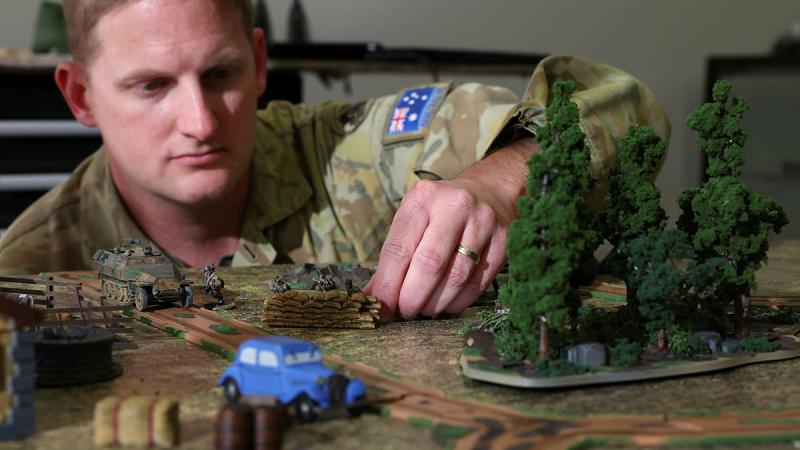 Sergeant Steven Richardson with terrain he 3D printed for Bolt Action war game at the Latchford Barracks war-gaming centre. 