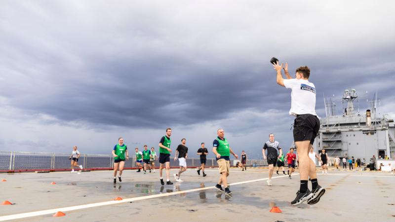 HMAS Choules marine technicians and maritime warfare officers play off in a gruelling round of netball gridiron while on a regional presence deployment. 