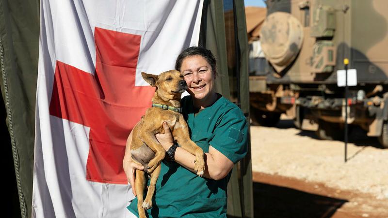 Australian Army soldier Corporal Lianne Salerno, from 3rd Health Battalion, with local patient, Simba, prior to being returned to his family during the 2024 Army Aboriginal Community Assistance Programme in Amata, SA.