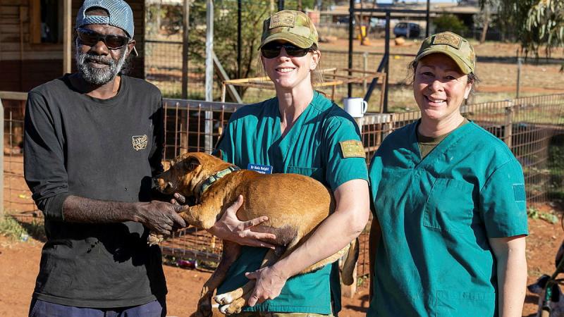 Australian Army Veterinary Officer Captain Naia Knight and Combat Medical Attendant Corporal Lianne Salerno deliver Simba back to his owner, Russel Watson, after treatment in Amata, SA. 