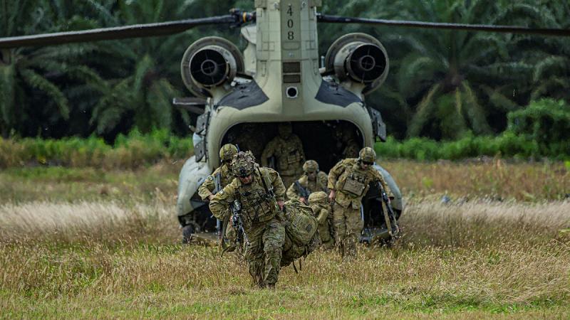 Soldiers from Rifle Company Butterworth exit a United States Army Chinook during the Field Training Exercise during Exercise Keris Strike in Sabah, Malaysia.