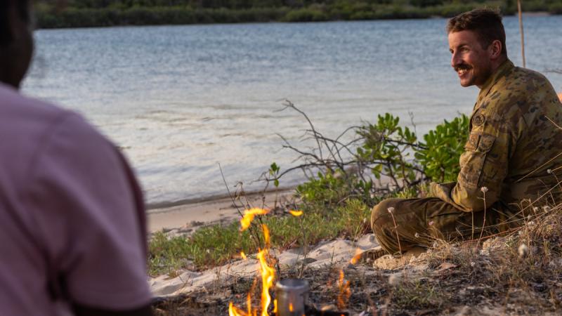  Army Lance Corporal Nathan Carnie, from 1st Combat Engineer Regiment, speaks to a Yolngu man during a tour of the Gove Peninsula during Exercise Predator's Run.