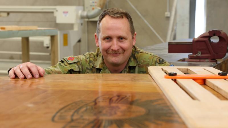  Army soldier Sergeant Alan Rowell with the conference table he made for the Chief of Army through the Holsworthy MakerSpace.