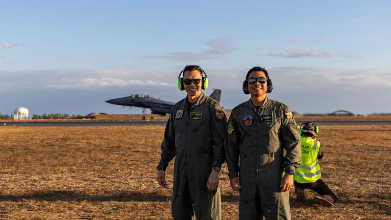 Major (U) Mohamad Azmi Afflon (left), and Major (U) Mohammad Aliff Zulkifli from the Royal Brunei Air Force on the Darwin flight line during aircraft take-offs for night flying missions as part of Exercise Pitch Black 24. 