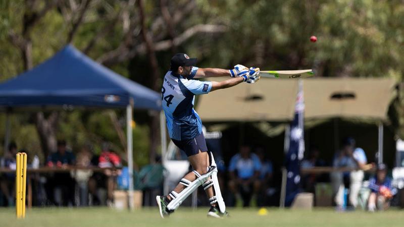 A Royal Australian Air Force batter hits the ball during a friendly T10 Cricket match against the Royal New Zealand Air Force during Exercise Pitch Black 24.