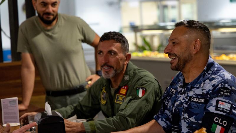Italian Country Liaison Officer Flight Lieutenant Guy Strazzeri, right, has breakfast with Italian Defence personnel at the Defence Accommodation Precinct – Darwin during Exercise Pitch Black.