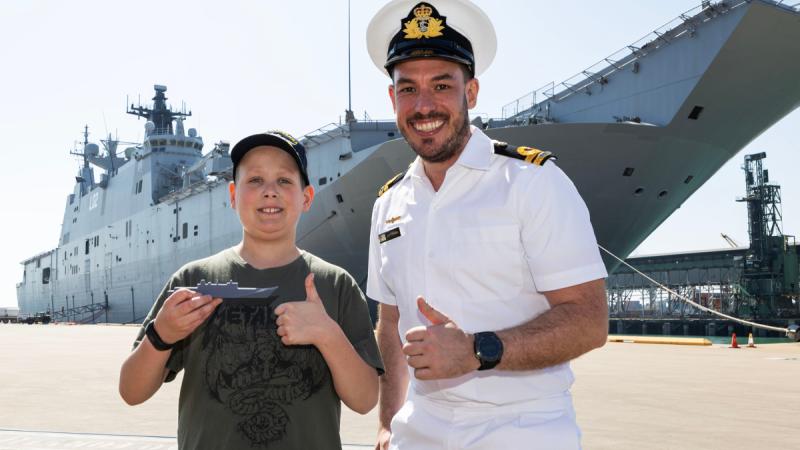 Saxon and Lieutenant Ben Jackson in front of HMAS Canberra in Townsville, QLD.