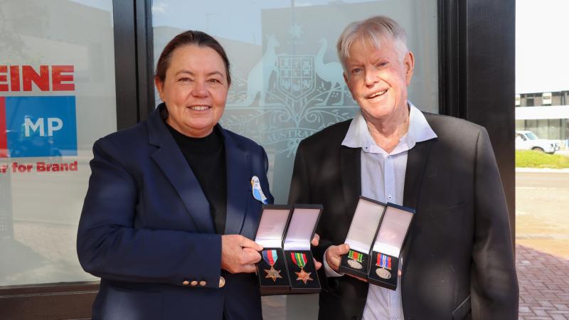 Madeleine King MP handing over Sergeant John Brislin’s WWII medals to his son, Bruce Brislin, outside her office in Rockingham, WA. Photos: Supplied