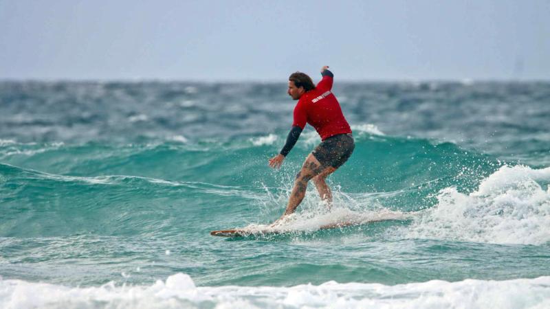 Lance Corporal Mitch Adams competing in the Kirra Longboard Klassic at the Gold Coast.