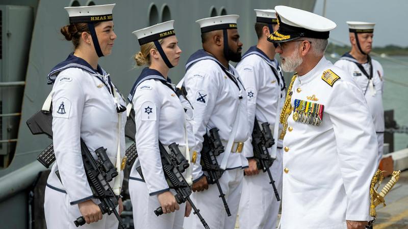 Commander Australian Fleet Rear Admiral Chris Smith speaks to a member of HMAS Melville's ceremonial guard during the ship’s decommissioning ceremony at Trinity Wharf in Cairns. Photos: Petty Officer Leo Baumgartner