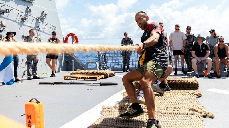 Able Seaman Filipe Crispim Dos Santos competes in the Tug of War event during HMAS Sydney’s Mini-Olympics competition  while on regional presence deployment. 