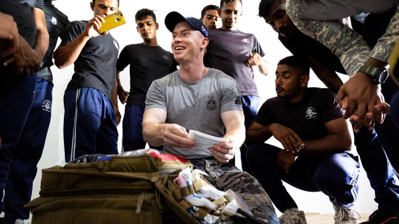 Leading Seaman Underwater Medic Leith Strachan and Sri Lanka Navy divers discuss diving related medical practices during Indo-Pacific Endeavour activities in Trincomalee, Sri Lanka.