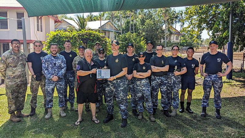 RAAF Sergeant Aaron Bennet (centre right) with 2 Squadron personnel after cleaning up Billeroy House Community Centre in Darwin.