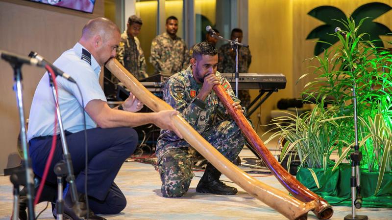 Flight Lieutenant James Evans and a member of the Maldives National Defence Force band play didgeridoos at a reception hosted by the Australian High Commission during Indo-Pacific Endeavour 2024. Photo: Australian High Commission Maldives.