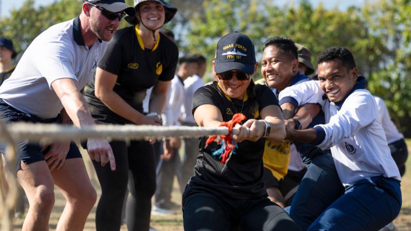 HMAS Perth crew and Indonesian Navy personnel participate in a tug-of-war competition at the 6th Main Naval Base Makassar in Indonesia. 