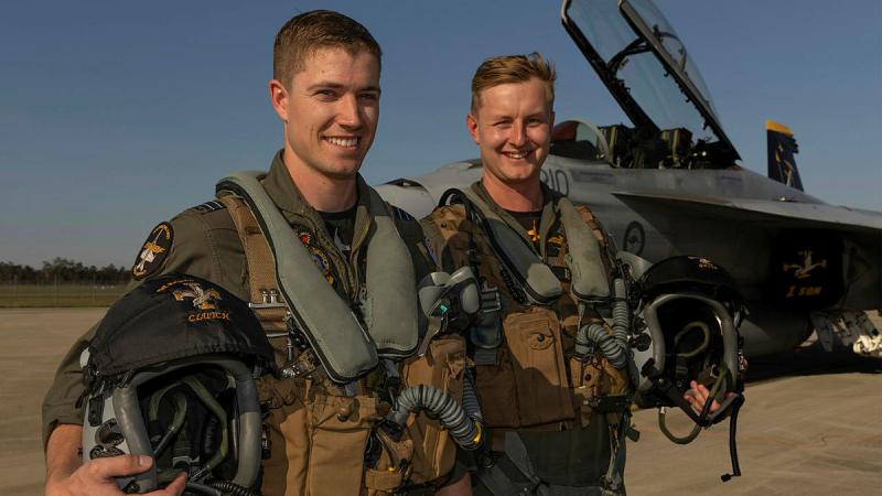 Aviators from 1 Squadron, Flight Lieutenants Nick and Slade, with a F/A-18F Super Hornet at RAAF Base Amberley prepare for their flying display.