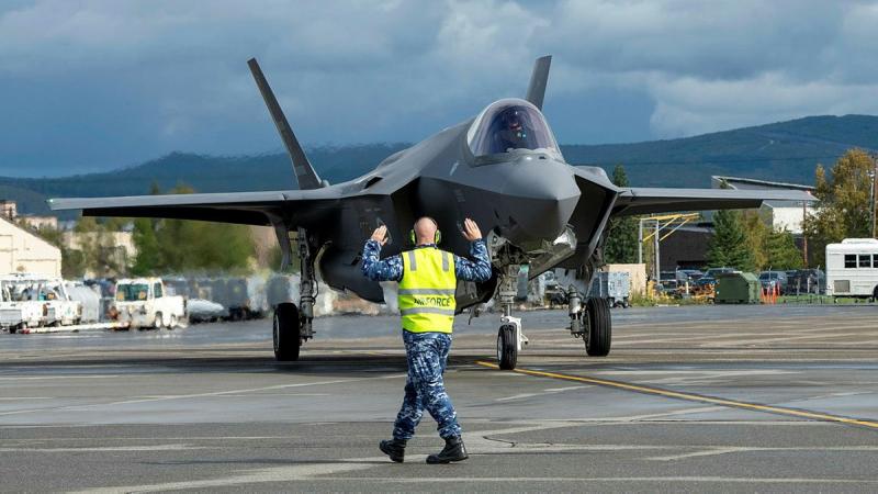 An aviator marshalls a 75 Squadron F-35A Lightning II at Eielson Air Force Base, Alaska.