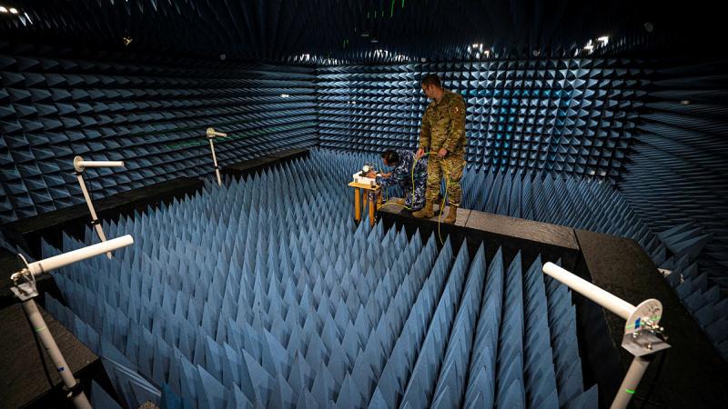 Personnel from the Australian Joint Positioning, Navigation and Timing Directorate, Joint Capabilities Group and Joint Navigation Warfare Centre align GPS test equipment in the JNWC anechoic chamber at Kirtland Air Force Base, New Mexico, in preparation for a GPS resilience test on April 15. 