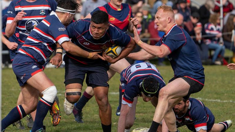 Staff Cadet Fetaiki Mafi (Tonga) charges through the defensive line during the grand final match between RMC Duntroon and local club Easts. 
