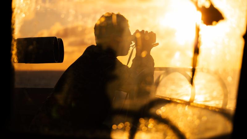 Able Seaman Boatswain’s Mate Luke Handley looks out from the bridge wing as HMAS Sydney takes part in a man overboard exercise.