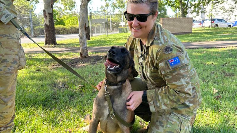 Veterinary officer in the ADF, Captain Alexandra Blecich, greets explosive detection dog Petra.