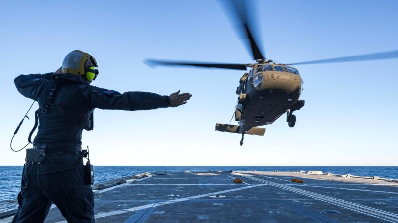An Army UH-60M Black Hawk conducts deck landings during first-of-class flight trials on board Navy’s multi-role aviation training vessel MV Sycamore in Jervis Bay.