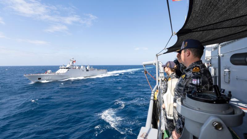Commanding Officer HMAS Perth Commander Ben Dalton, front, and Executive Officer Lieutenant Commander Gemma Casserly farewell TNI Indonesian Navy ship KRI Sulton Hassanuddin after officer of the watch manoeuvres during a regional presence deployment.