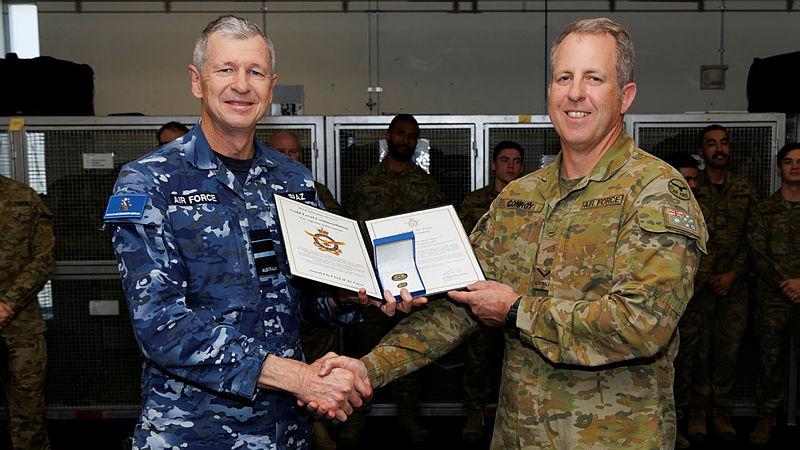 Air Commander Australia Air Vice-Marshal Glen Braz (left) awards Leading Aircraftman Samuel Conroy a gold-Level Commendation at 1 Security Forces Squadron, RAAF Base Williamtown.