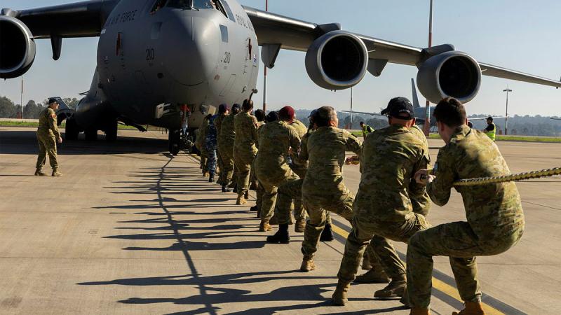 Members of 1 Expeditionary Health Squadron takes up the rope during the challenge at RAAF Base Amberley. Photos: Corporal Brett Sherriff