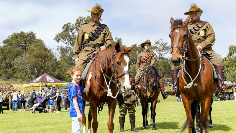 An attendee at the Perth ADF Open Day gets close-up to horses during the 10th Light Horse re-enactment on the main oval at Irwin Barracks. 