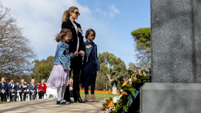 Major Angela Uphill and her two children lay a wreath during the 2024 Legacy Week launch at the Australian War Memorial, Canberra.