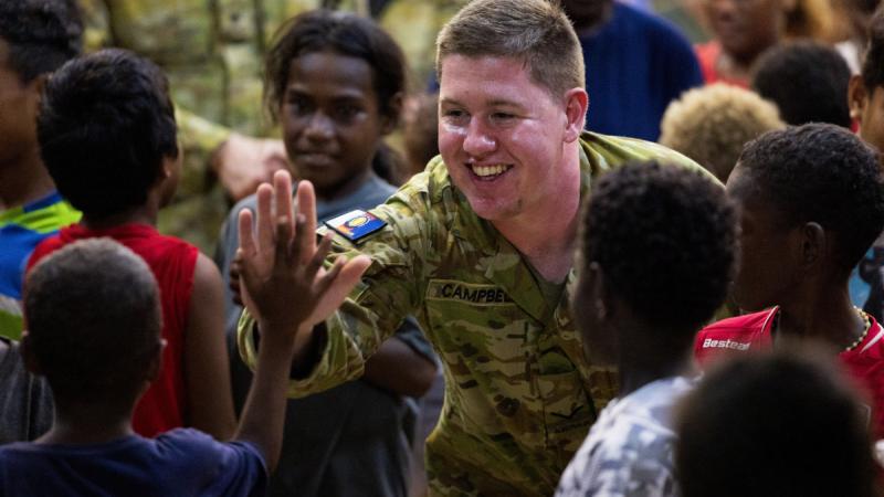  Army personnel attend church with local children during Operation Render Safe, Noro, Solomon Islands.