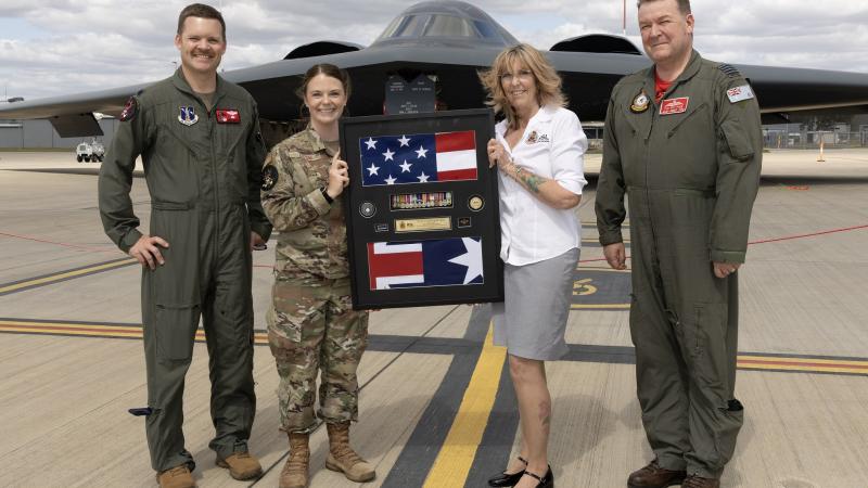 (L-R) Commander 110th Expeditionary Bomb Squadron Lieutenant Colonol Justin Meyer, Master Sergeant Emily Luzum, First Segea Ipswich Sub Branch of the Queensland Returned Services League Association representative, Mrs Debbie Wadwell and Officer Commanding 82 Wing Group Captain Paul Jarvis with a shadowbox received on behalf of the Russell family, at RAAF Base Amberley QLD.